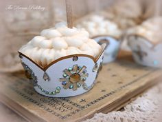 small cupcakes with white frosting are on top of an old fashioned book