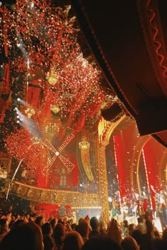 fireworks and confetti fill the night sky above a stage