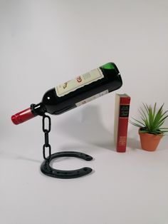 a wine bottle is chained to a book holder