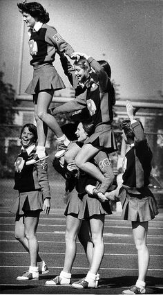 the girls are all wearing skirts and cheerleaders on their shoulders, while one girl is jumping in the air