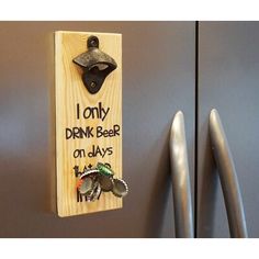 a wooden sign that says, i only drink beer on days with an elephant keychain