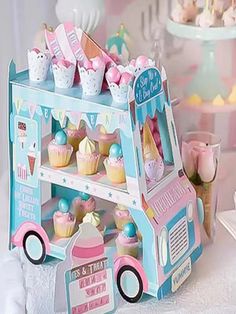 a pink and blue ice cream truck with cupcakes