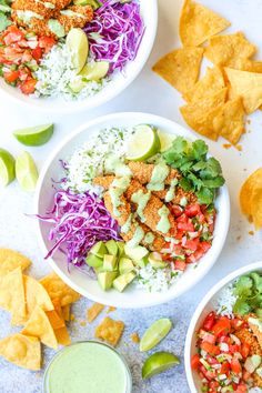 three white bowls filled with different types of food and garnished with tortilla chips