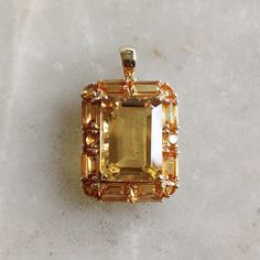 This stunning pendant is set in 14K Solid Yellow Gold with Natural Citrine with utmost precision. It is an unique gemstone pendant for nearly every occasion and is completely hassle-free jewelry. ITEM DETAILS * Gem: Citrine * Gem Size: 10X14mm 1pcs * Gem Shape: Octagon * Gem Size: 3X5mm 8pcs * Gem Shape: Octagon v* Gem Size: 3mm 2pcs * Gem Shape: Round * Gem Size: 2.5mm 5pcs * Gem Shape: Round * Gem Weight: 10.56 carats * Gold Purity: 14KT  * Gold Weight: 2.14 gram * Total Weight of the Pendant: 4.25 gram The Gold purity is guaranteed and it comes with authentic 14KT gold hallmark. Since my items are handmade, they are absolutely nickel and lead free. CUSTOMIZATION * Gemstone customization is available and it can be substituted with a gem of your choice. Kindly message me for the same. PAC Luxury Octagon Gemstones For Gifts, Elegant Orange Emerald Cut Jewelry, Luxury Citrine Octagon Jewelry, Exquisite Orange Gemstone Jewelry, Luxury Octagon Citrine Jewelry, Yellow Sapphire Jewelry With Gemstone Accents, Yellow Sapphire Jewelry With Gemstone Accents For Gift, Yellow Gold Topaz Gemstones As Gift, Elegant Yellow Sapphire Jewelry With Emerald Cut