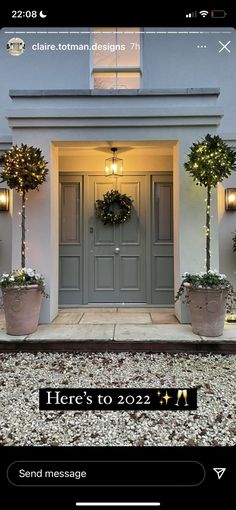 the front door to a house with two potted plants on it and an email message below