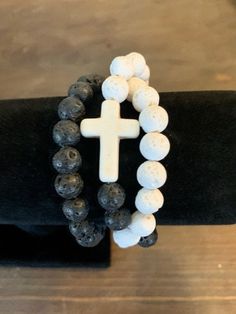 "NEW! Wrap around  Bracelet or wear as a Neckless! Offering His and Her Set, Sku LAHH -001  His comes in a 10mm Bead size with 2\" cross and Hers comes in a 8mm bead size with  1\" cross  New Wrap around, 10 mm Black Lava Rock, 1 mm Strong clear Stretch cord for easy wear, two inch White and Black Semi-Precious  Howlite cross. Offering His and Her Set, Sku LAHH -001  His comes in a 10mm Bead size with 2\" cross and Hers comes in a 8mm bead size with a 1\" cross  In Variation choose the Cross Col White Cross Bracelet Spiritual Style, Christian Jewelry Bracelets, Bible Verse Bracelet, Jesus Gifts, Christian Bracelets, Confirmation Gifts, Lava Rock, Lava Bead, Christian Jewelry