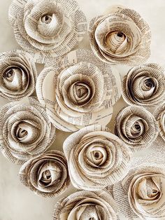 paper flowers made from old book pages are arranged in a circle on a white surface