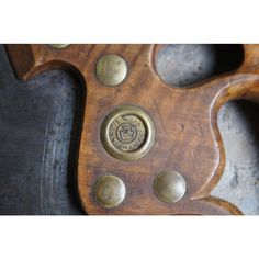 an old wooden object with metal rivets on it