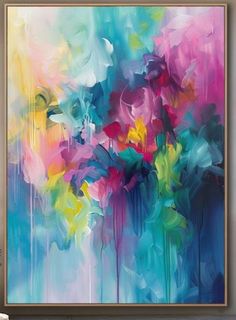 an abstract painting with blue, pink and yellow colors on the wall in a living room