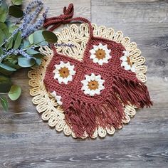 a crocheted doily with flowers on it