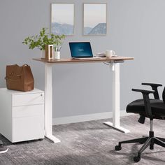 an office desk with a laptop on it