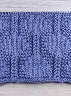 a blue knitted dishcloth sitting on top of a wooden table