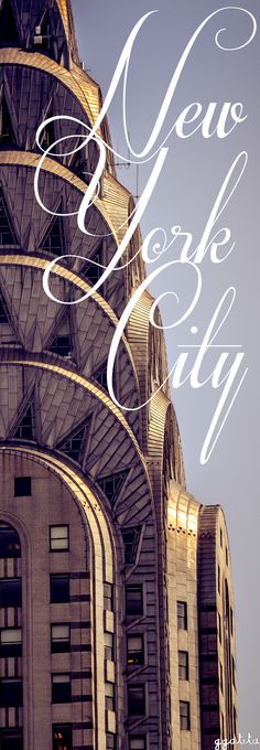 the words new york city written in white on top of a tall building with an ornate roof