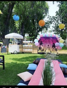 an outdoor party with balloons and decorations