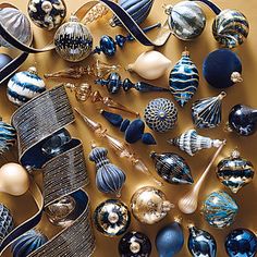 an assortment of blue and white christmas ornaments on a gold background with text overlay