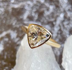 a yellow gold ring with a white diamond