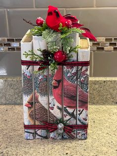 a gift wrapped in wrapping paper with cardinals on it