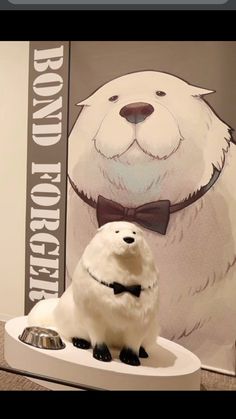 a stuffed polar bear sitting on top of a dog bowl in front of a poster