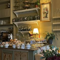 a coffee shop filled with lots of different types of food and drinks on top of shelves