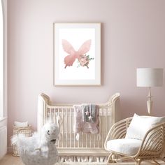 a baby's room with pink walls and white furniture, including a rocking chair