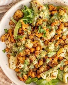 a white bowl filled with food on top of a table