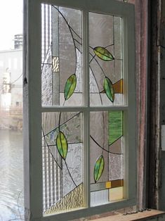 a stained glass window with green leaves on it