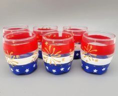 six red, white and blue glasses with stars on the rims are lined up