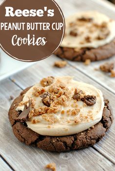 peanut butter cup cookies with white frosting and chopped walnuts on top, sitting on a wooden table