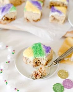 a piece of cake on a plate with a fork and confetti next to it