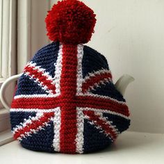 a knitted tea cosy with a british flag design