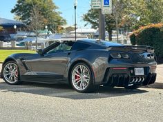 a black sports car is parked on the street