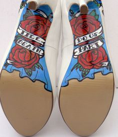 a pair of shoes with roses painted on them