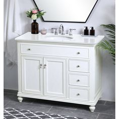 a white bathroom vanity with two sinks and a large mirror over the sink in front of it