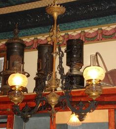 a chandelier hanging from the ceiling in a room with many lights on it