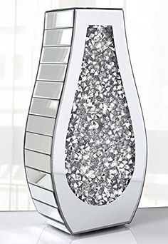 an artistic vase with silver glitter on it