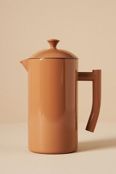 a brown coffee pot sitting on top of a table