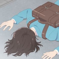 a person laying on the ground with a suitcase over their head and hands in front of them