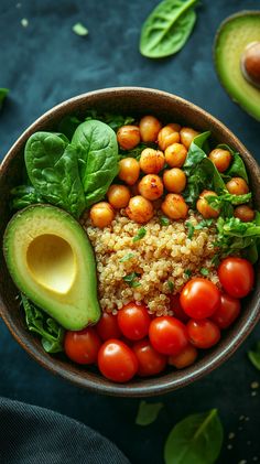 an avocado, tomatoes, spinach and couscous in a bowl