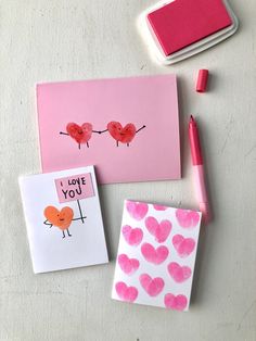 valentine's day cards and markers on a table