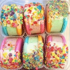 there are many colorful treats in the plastic container