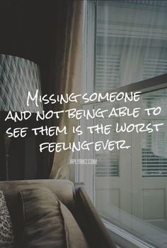 a couch sitting in front of a window with a quote on it that says missing someone and not being able to see them is the worst feeling ever