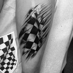 a black and white photo of a checkerboard tattoo