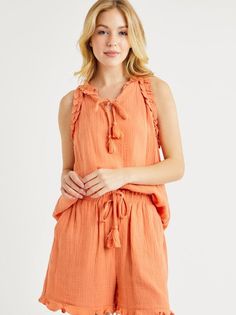 Summer style just got a playful upgrade with our Matchy Matchy Gauze Set in Coral Orange! Made from light and breezy gauze fabric, this set includes a sleeveless top with matching shorts for a coordinated look. The stylish details of tassels and ruffles add a fun touch to the coral orange color. Perfect for any sunny day! Color: Coral Orange Fabric: 100% Polyester Includes: x1 Top and x1 Bottom (Matching Set) Sizes: S-M-L, Regular Sizing. Sleeveless Ruffled Beach Set, Summer Ruffled Short Tops, Summer Sets With Ruffles And Sleeveless Design, Spring Vacation Sleeveless Sets, Sleeveless Summer Sets For Day Out, Sleeveless Sets For Spring Vacation, Summer Ruffle Set With Shorts, Summer Ruffled Short Sets, Summer Bohemian Sleeveless Sets