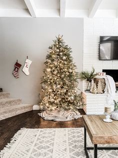 a living room with a christmas tree in the corner