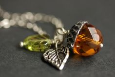 A delicate handmade crystal acorn necklace created with a bright amber orange colored glass crystal combined with a detailed silver plated leaf charm and green Czech glass leaf charm. If you would like a length of chain different than offered, please contact me for pricing. Check out the other colors if acorn necklaces offered in my shop! http://etsy.me/1iMZM8w Stop by and visit http://stumblingonsainthood.etsy.com to see more handmade designs! © Stumbling On Sainthood (StumblingOnSainthood@gmai Acorn Jewelry, Acorn Crafts, Acorn Pendant, Acorn Necklace, Feminine Jewelry, Valentines Sale, Jewelry Pendants, Charm Necklace Silver, Necklace Crystal