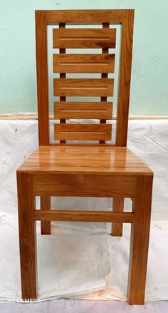 a wooden chair sitting on top of a white floor