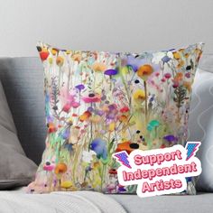 a pillow with an image of flowers on it and the words support independent artists above it