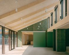 an empty building with lots of windows and doors