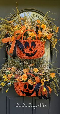 two pumpkins decorated with orange flowers and black ribbon hang from the front door for halloween decorations