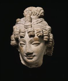 an ancient head is shown against a black background